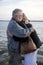 Older Middle-Aged Couple Hugging on Dock