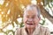 Older people for insurance concept : Portrait of Asian elder woman is smiling with her black tooth with happy at outdoor in sunny