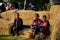 Older Phu Tai people sit and eat breakfast at stack rice straw i