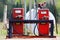 Older red gas pumps with diesel and gas