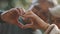 Older retired couple making heart with their hands. Selective focus