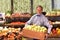 Older seller with a staircase of apples in the supermarket - sal