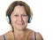 Older senior hispanic woman listening to music on her headphones
