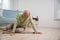 Older senior man headache lying on the floor after falling