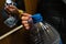 Older senior woman`s hand holding a big blue plastic bottle in an elevator