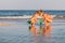 Older sister playing with younger brother aground near the shore on summer vacation