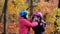 The older sister puts on the younger one a medical mask and a Bicycle safety helmet in the fall . The concept of protection FROM