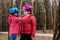 The older sister puts on the younger one a medical mask before riding a Bicycle. The concept of protection FROM covid-19