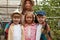 Older sister with younger brother and sisters on excursion in the garden