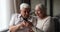 Older spouses look at cellphone read sms scream with joy