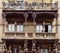 Older woman on balcony of typical residential palace at Milan`s Porta Venezia neighbourhood