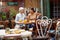 An older woman enjoying a company of her young female friend while they have a drink in the bar. Leisure, bar, friendship, outdoor