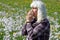 An older woman has hay fever