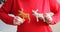 Older woman improvising with homemade cookies in the shape of a deer on a red jumper. Natural edible Christmas decor