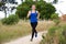 Older woman jogging in countryside