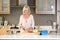 Older woman in kitchen cutting vegetables