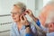 Older woman and man or pensioners with a hearing problem