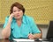 Older woman on the phone at her desk