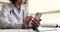 Older woman physician holding smartphone typing answer to patient