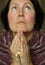 Older woman in prayer