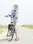 Older woman relaxing with bike on countryside path