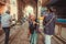 Older woman shopping and crowd of walking people on historical indian street