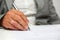 Older woman signing the document