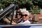 older woman and a young woman driving a convertible