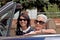 An older woman and a young woman driving a convertible