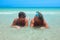 Older women in bathing suits on the beach talking relaxing.