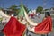 Older women and children marching through streets of Puerto Morelos carrying Mexican flag and Catholic statues, Yucatan