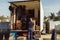 older worker loading cardboard boxes onto moving truck