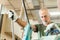 Older worker threading a steel bar in an industrial factory