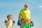 Older - young man boxing. Handsome elderly man practicing boxing kicks. Senior trainer and little boy wearing boxing