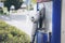 Oldtime or vintage Red white blue color fuel gasoline station box and dispenser in blur Europe background. S