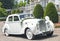 Oldtimer car dressed up with white flowers for wedding ceremony