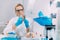 Olfactory Test in the Lab. Female Scientists Smelling a Sample in the Glass Flask