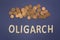 Oligarch written with wooden letters on a blue background