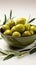 Olive bowls accented by charming olive twigs against a clean white backdrop