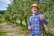 Olive grower working in olive grove.