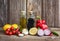 Olive oil, balsamic vinegar and vegetables on old wooden background