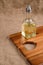 Olive oil in bottle on acacia wood board