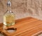 Olive oil in bottle on acacia wood board