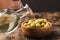 Olive oil in a bottle and fruits of olives in a bowl. Olive oil bottle and olives on wooden table