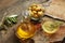 Olive oil in a bowl and carafe on vintage wooden boards.