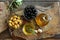 Olive oil in a bowl and carafe on vintage wooden boards.