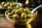 Olive oil in a bowl with spoon on green olive fruits background
