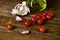 Olive oil, cherry tomatoes and garlic on a wooden table