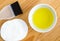 Olive oil in a small ceramic bowl for preparing homemade spa face and hair masks. Ingredients for diy cosmetics.
