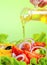 Olive oil stream and healthy fresh vegetable salad